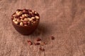 Deep fried peanuts in clay bowl over rustic wicker background. Selective focus Royalty Free Stock Photo