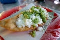 Deep-Fried Quesadilla topped with salsa in Mexico City