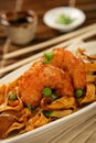 Deep fried scampi with Asian noodles and green pea