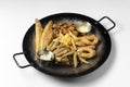 Deep fried set made from french fries, onion rings, big and small fried fish served in a wok over white background. Royalty Free Stock Photo