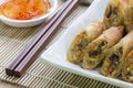 Deep fried spring rolls, Por Pieer Tod or Fried spring rolls Thai Spring Roll on white dish on wooden table,Thai and Chinese Royalty Free Stock Photo