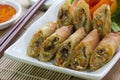 Deep fried spring rolls, Por Pieer Tod or Fried spring rolls Thai Spring Roll on white dish on wooden table,Thai and Chinese Royalty Free Stock Photo