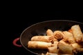 Deep fried spring rolls surve on the pan in dark background