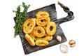 Deep fried squid calamari rings breaded on a cutting board. Isolated on white background, Top view. Royalty Free Stock Photo