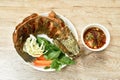 Deep fried striped snake head fish with salt eat couple vegetable and dipping spicy sauce on plate Royalty Free Stock Photo