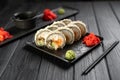 Deep fried sushi rolls with salmon and philadelphia cream cheese on black background. Hot tempura sushi set with tuna Royalty Free Stock Photo