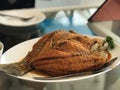 Deep fried tilapia fish in white dish on the table. Royalty Free Stock Photo