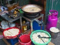 Deep fried tofu cooking in big pan or wok filled with frying oil. Street food stall in Vietnam, junk unhealthy eating