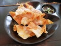 Deep Fried Wonton on black dish with plum sauce Royalty Free Stock Photo