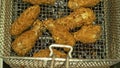 Deep fryer with boiling oil and chicken. Large, deep fryer container for frying food Buffalo wings. Restaurant deep