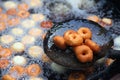 Deep frying medu vada in the pan. Medu Vada is a savoury snack from South India, very common street food in the India.