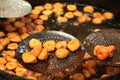 Deep frying medu vada in the pan. Medu Vada is a savoury snack from South India, very common street food Royalty Free Stock Photo