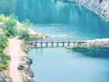 Deep grand canyon with blue lake at bottom.  Many roads Royalty Free Stock Photo