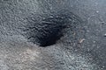 Deep hole in the paved road Royalty Free Stock Photo