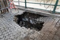 Deep hole in pedestrian sidewalk area Royalty Free Stock Photo