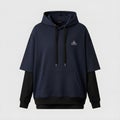 Deep navy-blue high-end layered hoody on a long sleeve placed against a plain white backdrop Royalty Free Stock Photo