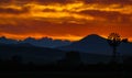 Deep orange sky with a contrasted country view of a windmill