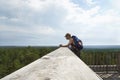 Hiker high up looking at wide view.