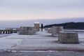 Deep perspective of a man on a pier in winter.