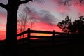 Shades of color at sunset over a rural fence