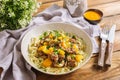 Deep plate with spaghetti, minced meat, chopped parsley, yellow bell pepper. Nearby is a bowl with sauce, a fork and a knife, a ta Royalty Free Stock Photo