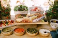 Deep platter of appetizers on the table with cutting board with cold meats and cheese and caprese and salad trays. Royalty Free Stock Photo