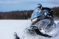 In deep powder snowdrift snowmobile rider driving fast Royalty Free Stock Photo