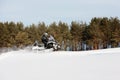 In deep powder snowdrift snowmobile rider driving fast