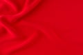 Deep red silk smooth wavy background with copy space. Royalty Free Stock Photo