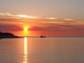 Deep red sunset and sail boat at Fannie bay