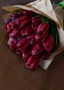 Red tulip bouquet on wooden background Royalty Free Stock Photo