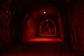 Deep red tunnel with spotlights in the rock Royalty Free Stock Photo