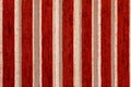 Red vertical striped synthetic woven upholstery fabric close-up texture and background Royalty Free Stock Photo