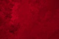 Deep red winter background or wallpaper. Rich saturated bright color. Tinted grainy backdrop in dark and light tones. Surface of Royalty Free Stock Photo