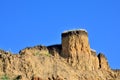 Deep sandy cliff on the background of blue sky.