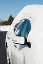 Deep snow on top of white car in drive Royalty Free Stock Photo
