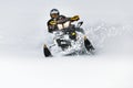 In deep snowdrift snowmobile rider make fast turn. Riding with fun in deep snow powder during backcountry tour. Extreme sport
