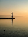 Deep sunrise light illuminating the lighthouse of Geneva harbour.