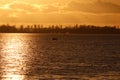 Deep sunshine setting over large lake