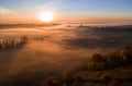 Deep thick fog in the valley. Long shadows from the trees. Atmospheric beautiful dawn. Aerial drone photo. Amazing mood Royalty Free Stock Photo