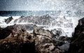 Deep view over lava rocks with breaking of waves Royalty Free Stock Photo