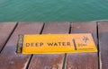 Deep water warning sign on lake side