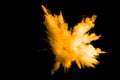 Deep Yellow color powder explosion cloud isolated on black background