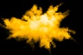 Deep Yellow color powder explosion cloud isolated on black background Royalty Free Stock Photo