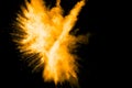 Deep Yellow color powder explosion cloud isolated on black background Royalty Free Stock Photo