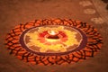 Diwali celebration - Diya oil lamps lit on colorful rangoli, Indian festival diwali and colourful rangoli and diya in centre Royalty Free Stock Photo