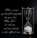 Deepest condolence white sand timer on black background with text Royalty Free Stock Photo