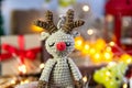 Deer crocheted on a wooden background. The concept of a cozy, magical Christmas and New Year