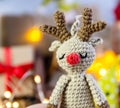 Deer crocheted on a wooden background. The concept of a cozy, magical Christmas and New Year