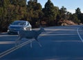 A deer crosses Desert View Drive in Grand Canyon National Park to get to the forest, stopping traffic in late afternoon Royalty Free Stock Photo